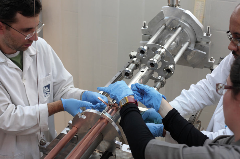 High production Intertwisted titanium, zirconium and vanadium wires being assembled into Sirius vacuum chambers in the NEG-coating rig at the Brazilian Light Source Laboratory. These are then inserted into a solenoid where a DC magnetron sputtering process completes the coating process. When fully loaded, the rig can simultaneously coat six 3.2 m-long vacuum chambers. (LNLS)